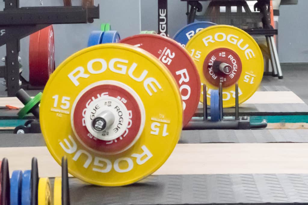 Barbell and weight plates racked at the gym